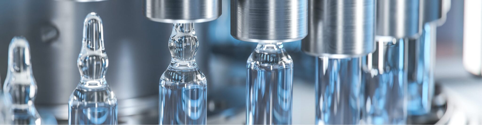 Glass vials emerging from a machine